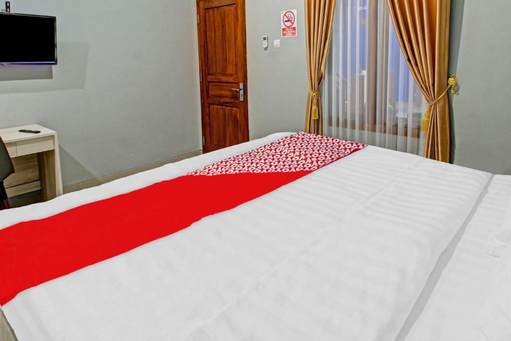 Postel nebo postele na pokoji v ubytování Super OYO 90767 Gm Guest House