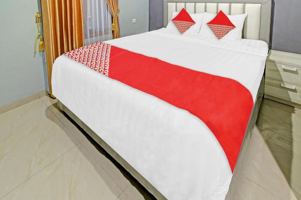 Postel nebo postele na pokoji v ubytování Super OYO 90767 Gm Guest House