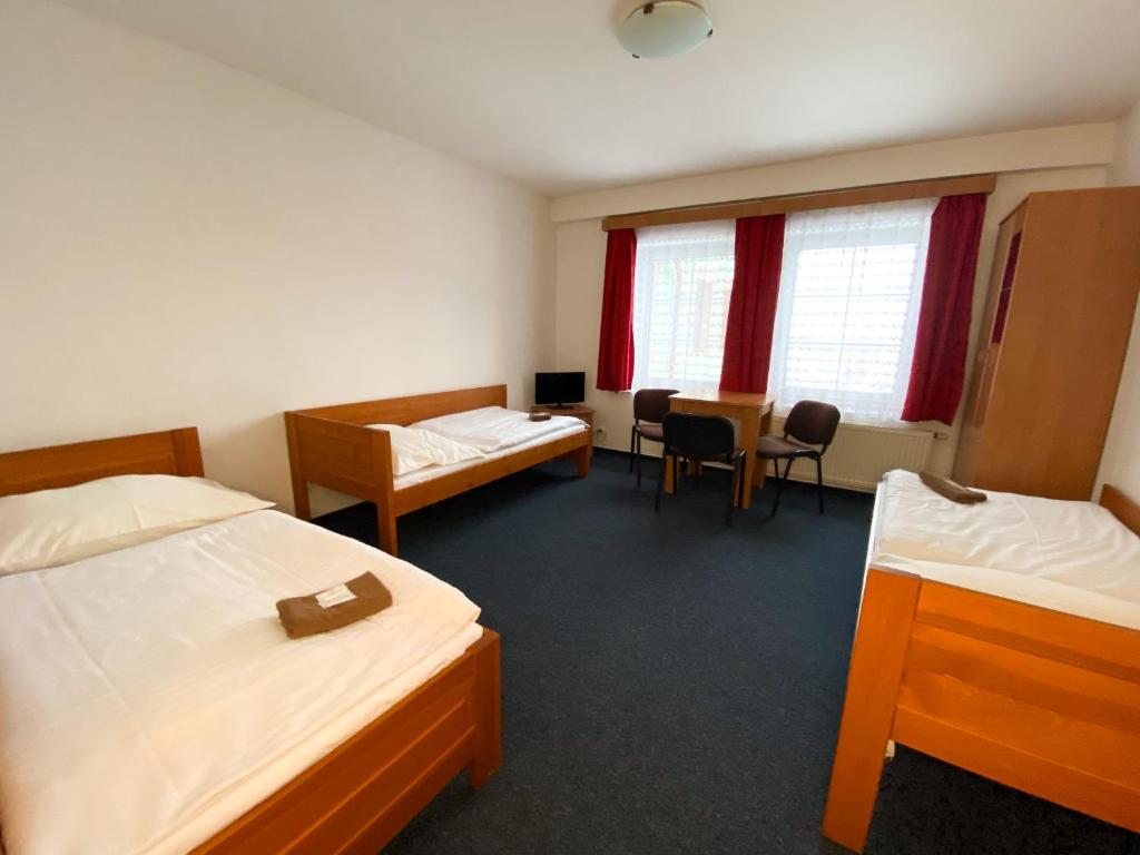 Postel nebo postele na pokoji v ubytování Hotel Koruna