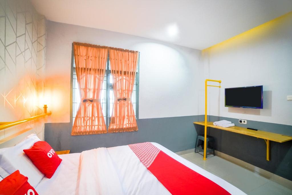 Postel nebo postele na pokoji v ubytování Capital O 90874 Millenium Inn 2