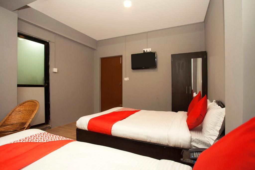 Postel nebo postele na pokoji v ubytování OYO 587 Hotel Tradition Inn