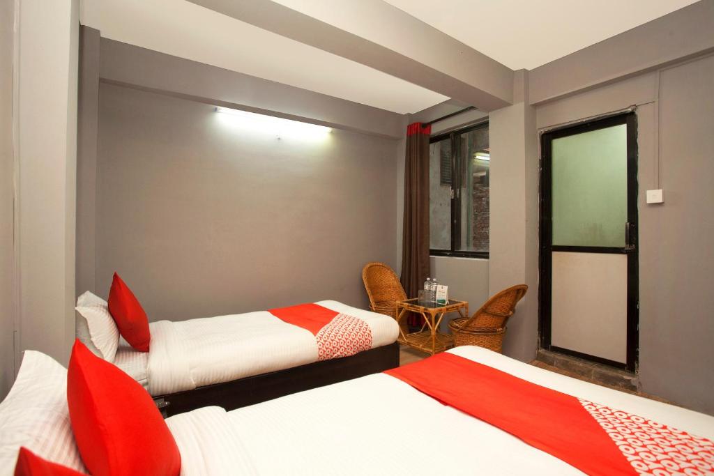 Postel nebo postele na pokoji v ubytování OYO 587 Hotel Tradition Inn