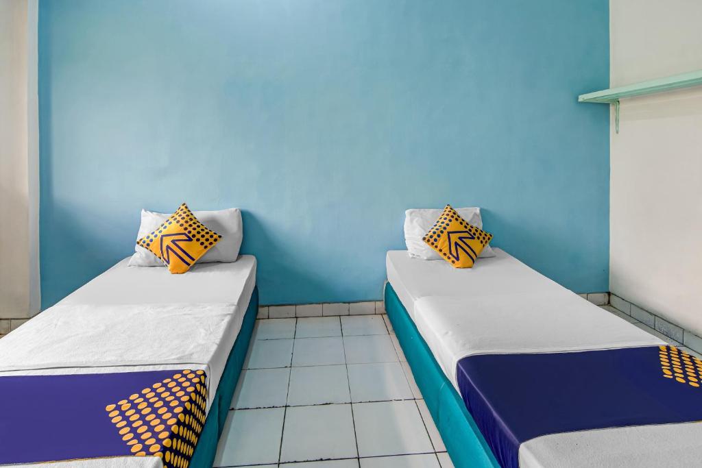Postel nebo postele na pokoji v ubytování SPOT ON 90964 Hotel Margadana