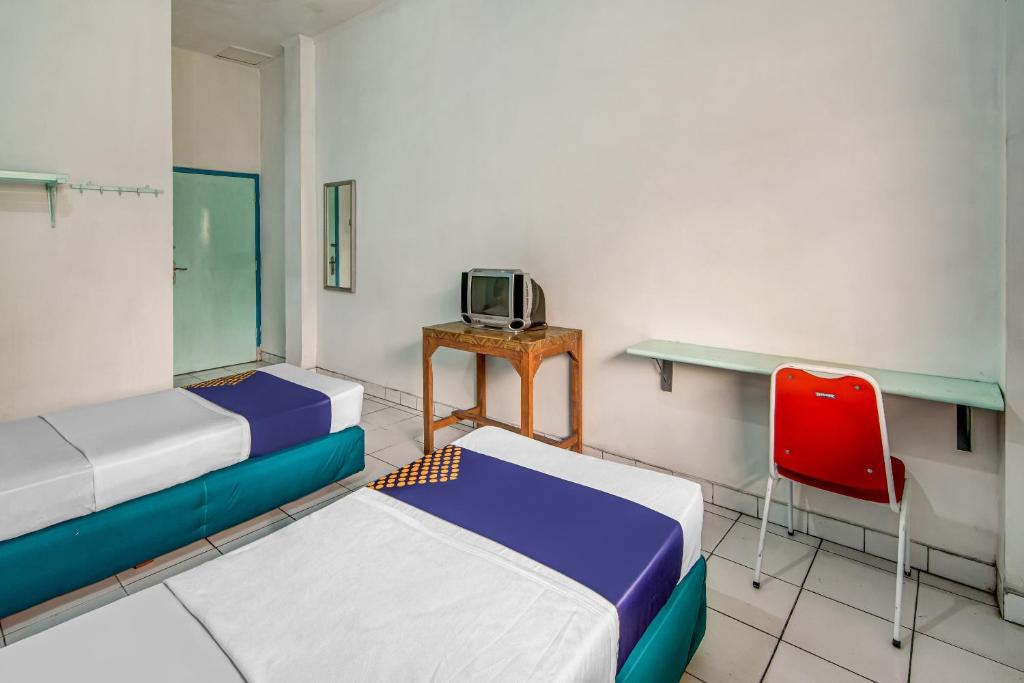 Postel nebo postele na pokoji v ubytování SPOT ON 90964 Hotel Margadana