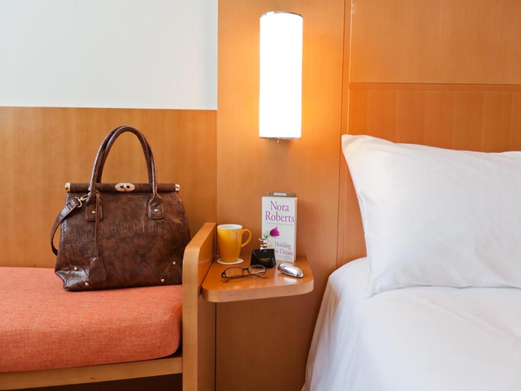 Ein Bett oder Betten in einem Zimmer der Unterkunft Ibis Abu Dhabi Gate