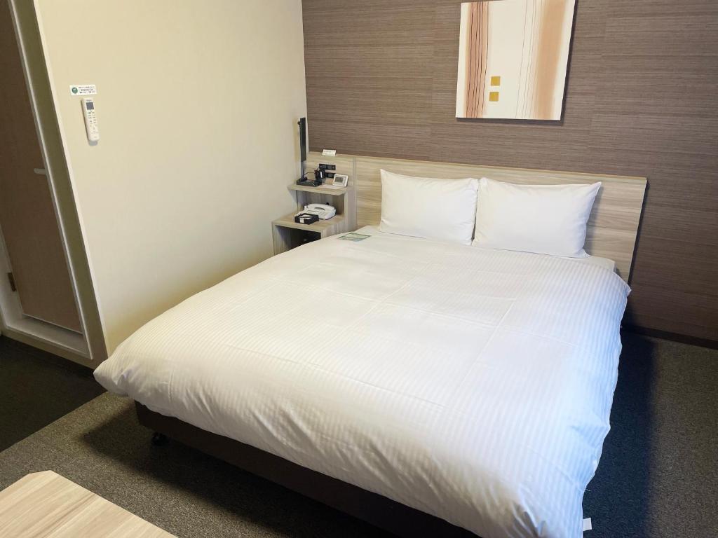 Postel nebo postele na pokoji v ubytování Hotel Route-Inn Takefu Inter