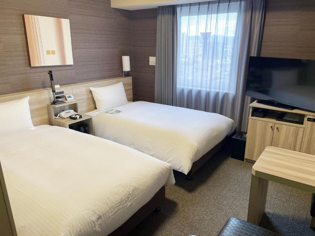 Postel nebo postele na pokoji v ubytování Hotel Route-Inn Takefu Inter