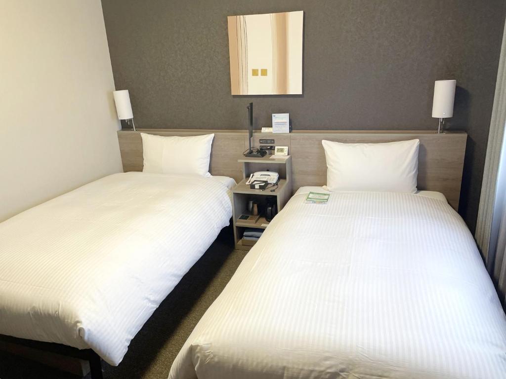Postel nebo postele na pokoji v ubytování Hotel Route-Inn Takefu Inter