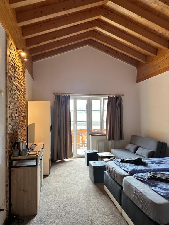 a living room with a bed and a couch at Touristenheim Bergfreude in Leukerbad