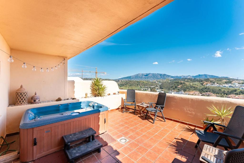 a hot tub on the balcony of a house at Las Terrazas in La Cala de Mijas