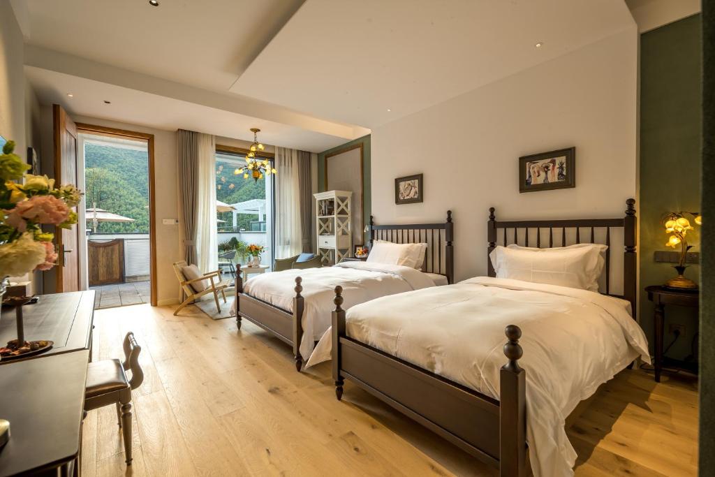 Postel nebo postele na pokoji v ubytování Moganshan Xinyuanju Homestay