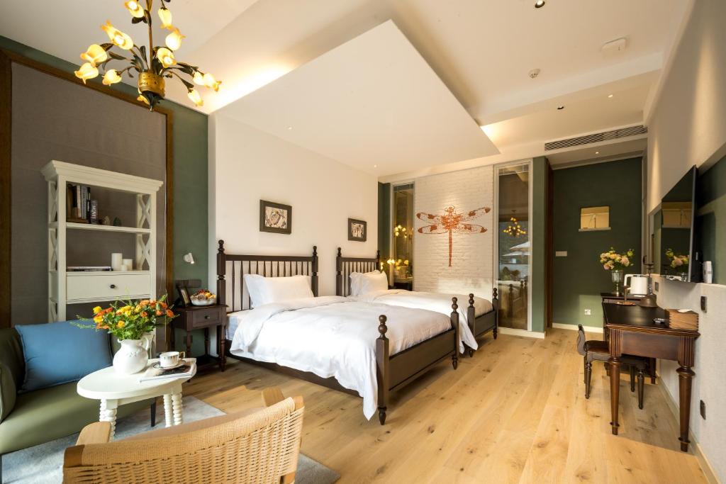 Postel nebo postele na pokoji v ubytování Moganshan Xinyuanju Homestay