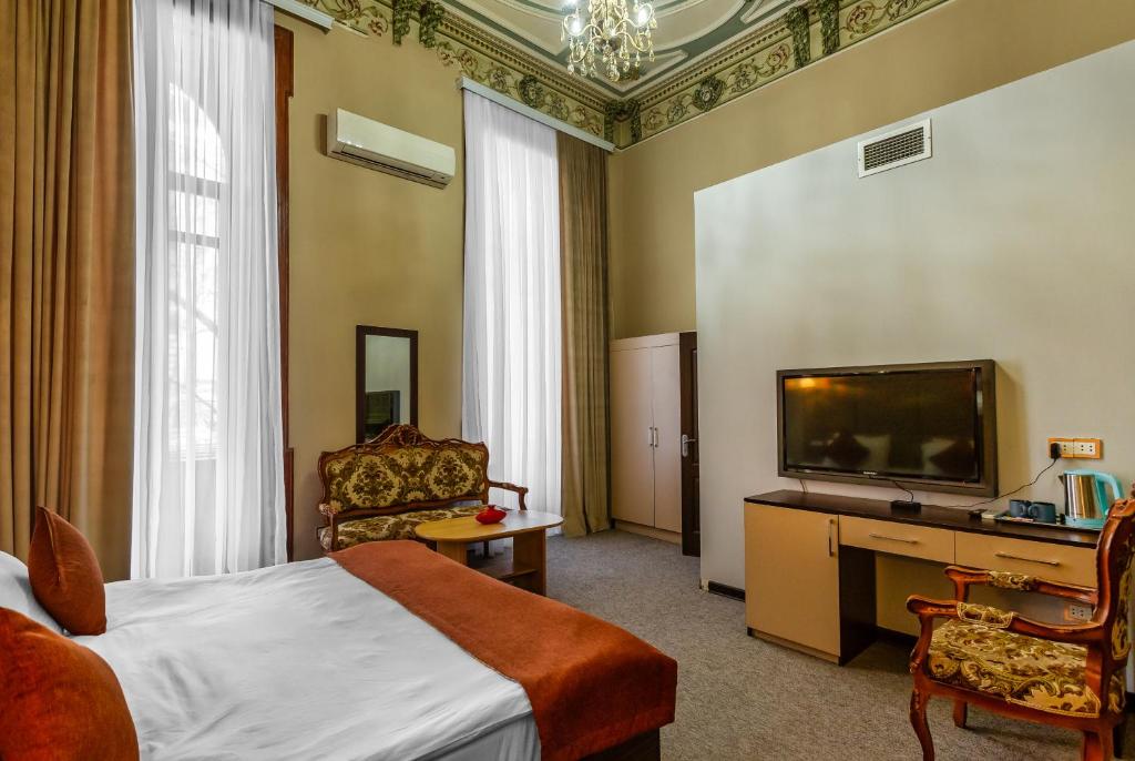 Postel nebo postele na pokoji v ubytování Garden Inn by NHG