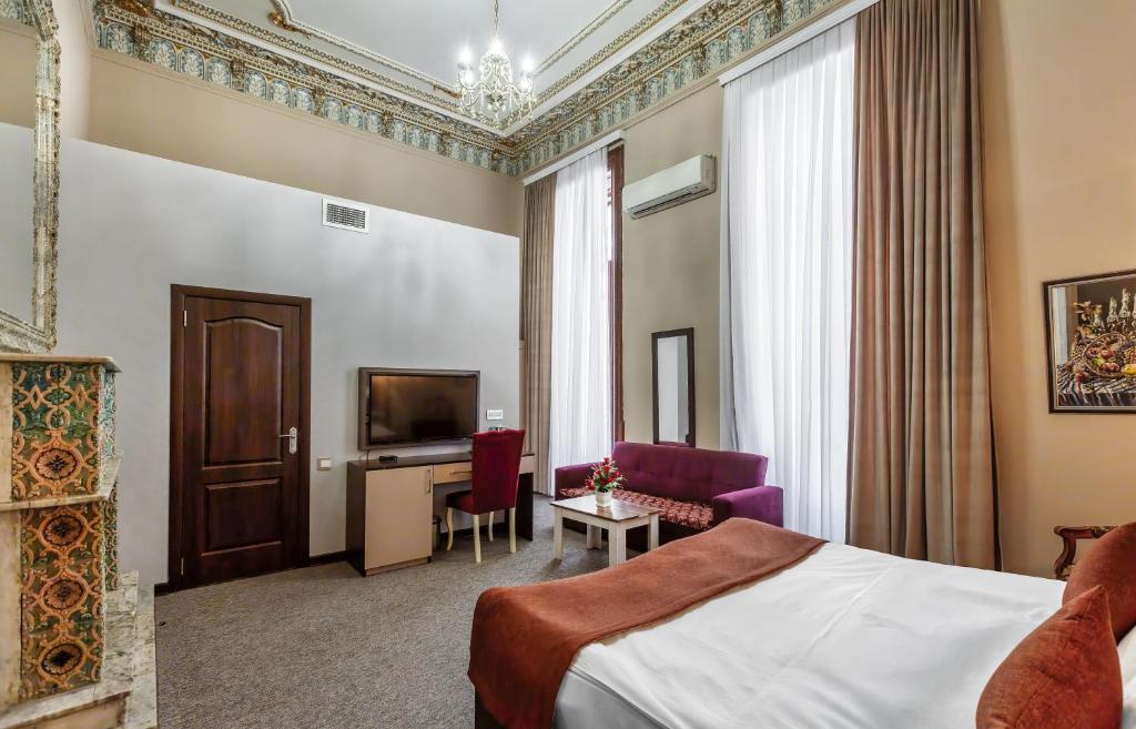 TV a/nebo společenská místnost v ubytování Garden Inn by NHG