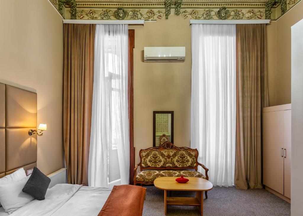 Postel nebo postele na pokoji v ubytování Garden Inn by NHG