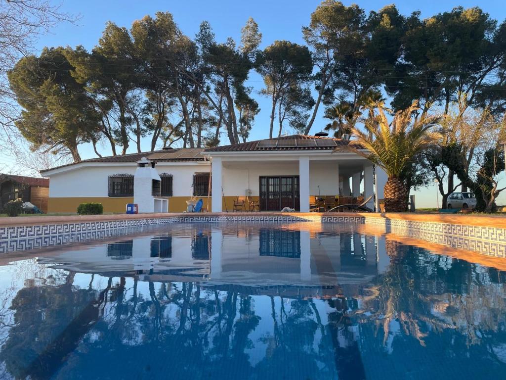 a house with a swimming pool in front of it at Casa Rural Hanega in Manzanares