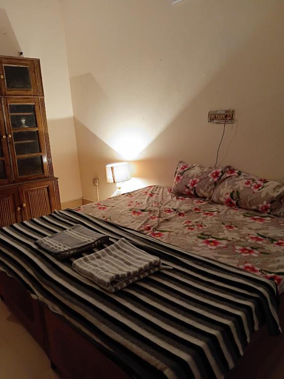 a bedroom with a large bed with a keyboard on it at Geeta Villa in Lucknow