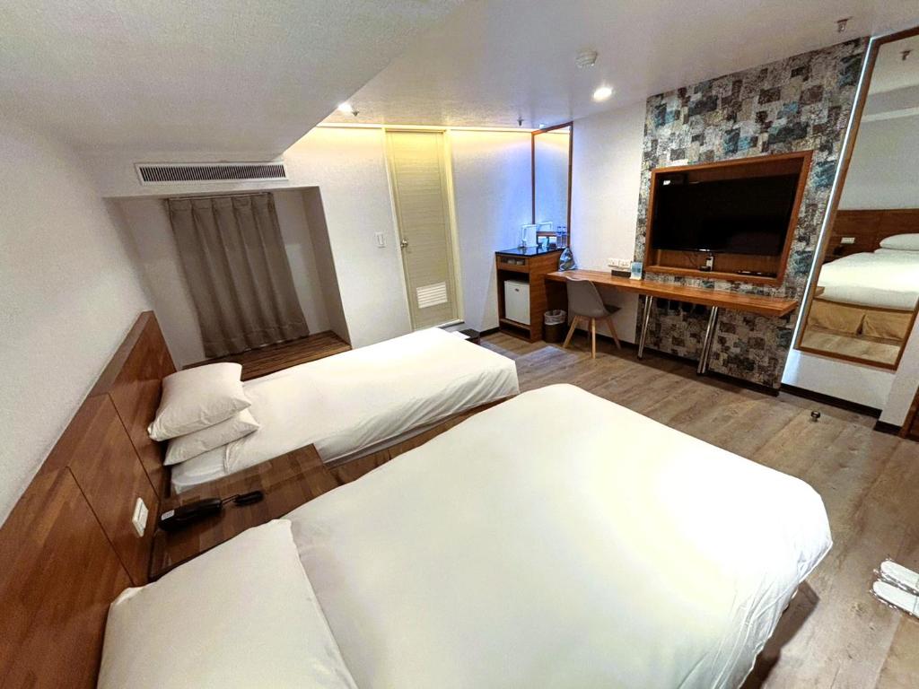 Postel nebo postele na pokoji v ubytování 雲沐行旅 Hotel Cloud Arena-Daan