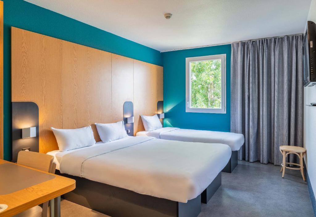 Postel nebo postele na pokoji v ubytování B&B HOTEL Lyon Eurexpo Chassieu