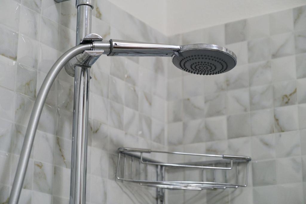 a shower with a shower head in a bathroom at Smart and Sea in Tortoreto Lido