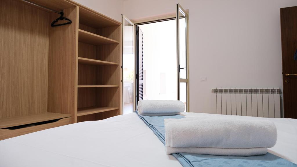 a bedroom with a bed with towels on it at Smart and Sea in Tortoreto Lido