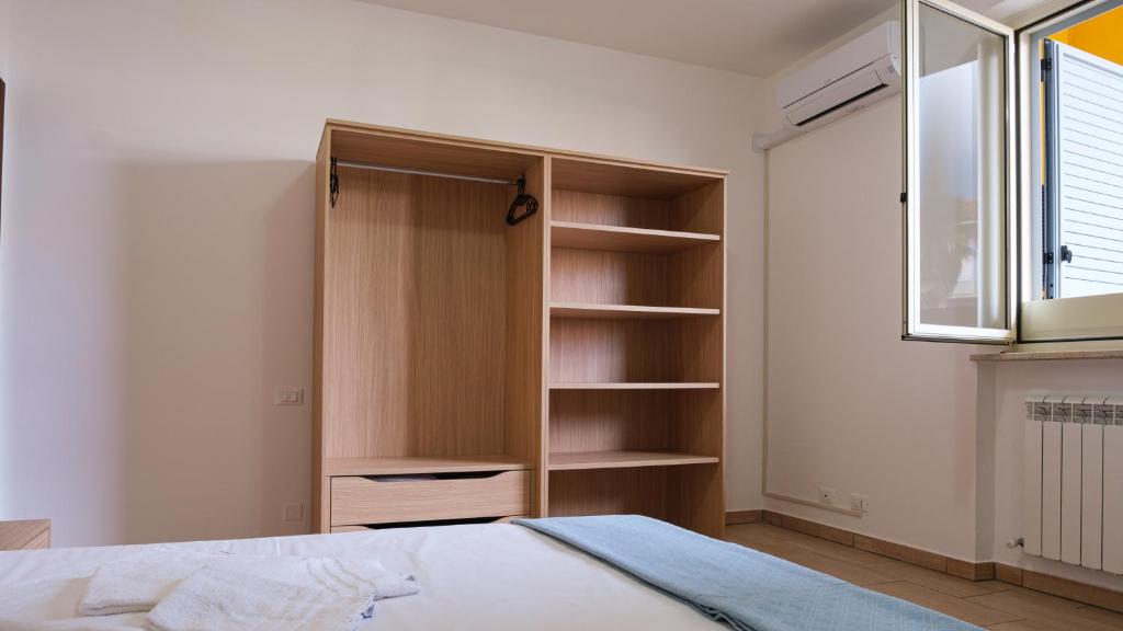 a bedroom with a closet and a bed and a window at Smart and Sea in Tortoreto Lido