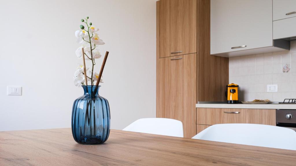 a blue vase sitting on a wooden table in a kitchen at Smart and Sea in Tortoreto Lido