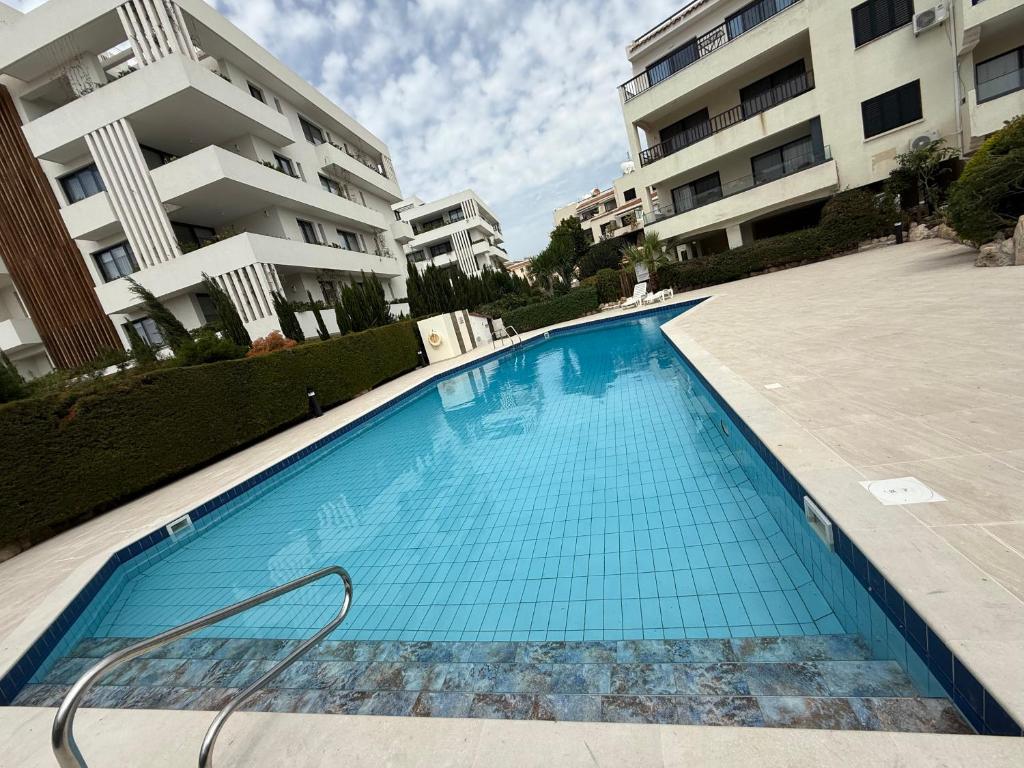 a swimming pool in front of a apartment building at Kings Avenue - Natalia's Apt in Paphos