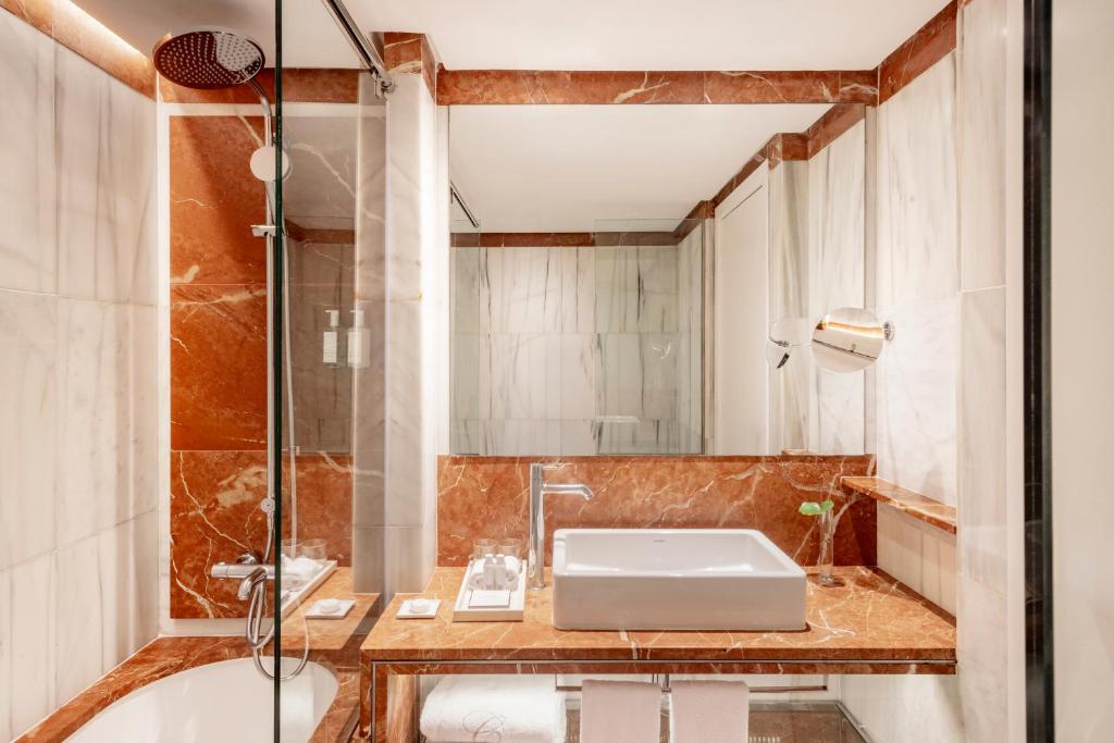 a bathroom with a sink and a shower at Claris Hotel & Spa GL, a Small Luxury Hotel of the World in Barcelona
