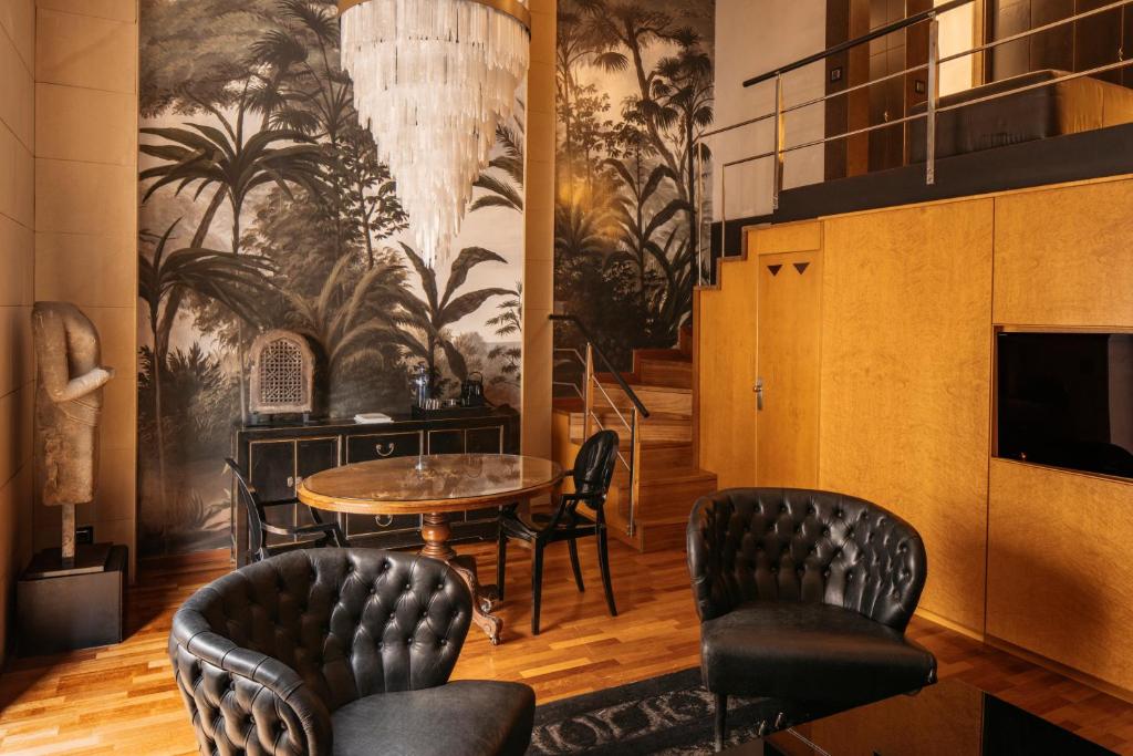 a dining room with a table and chairs at Claris Hotel & Spa GL, a Small Luxury Hotel of the World in Barcelona