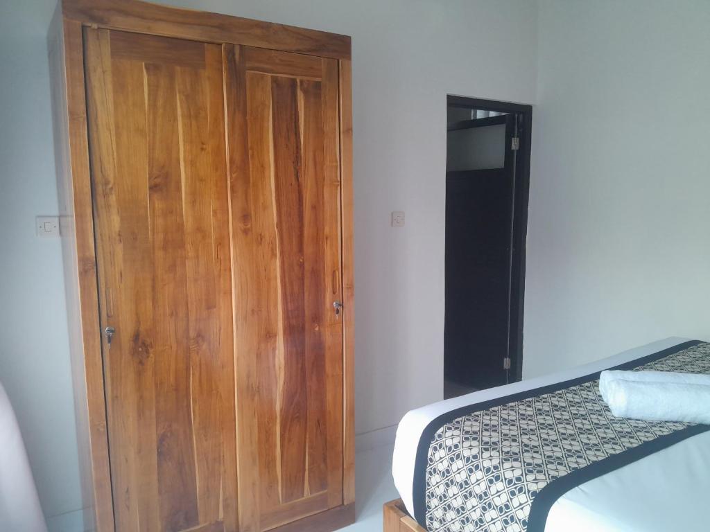 Postel nebo postele na pokoji v ubytování Tirta Sari House