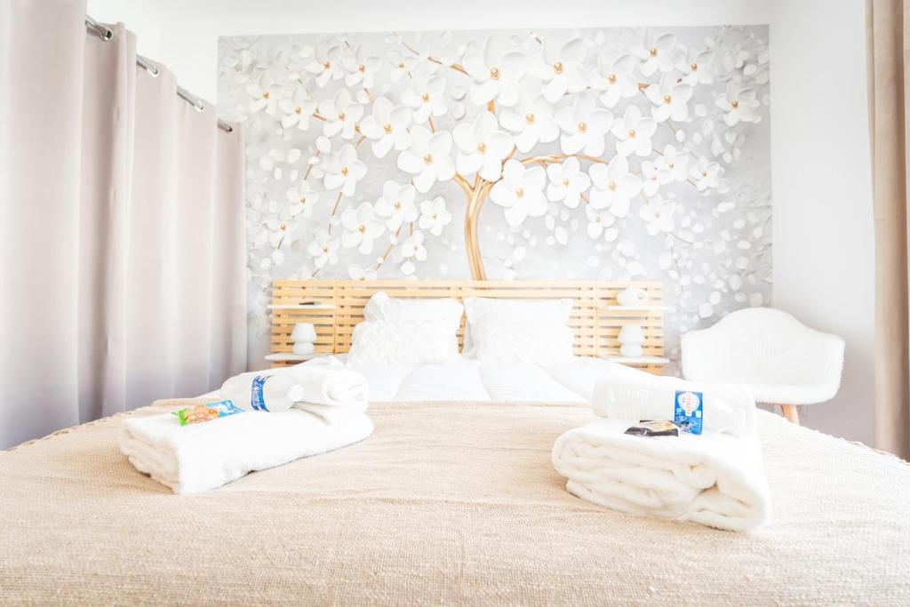 a bedroom with a bed with towels on it at Appartement Stylé pour 4 in Châlons-en-Champagne