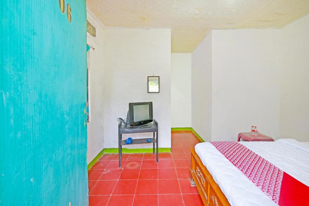 Postel nebo postele na pokoji v ubytování SPOT ON 91270 Hotel Arimbi