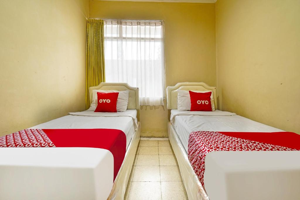 Postel nebo postele na pokoji v ubytování Super OYO 91350 Garden Hostel