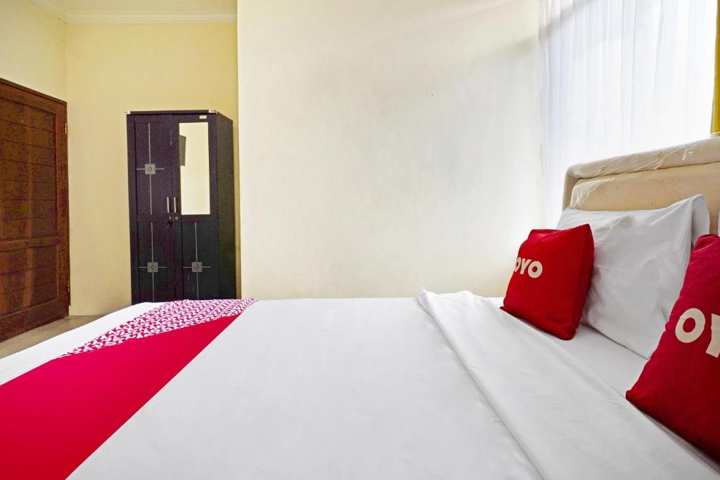 Postel nebo postele na pokoji v ubytování Super OYO 91350 Garden Hostel