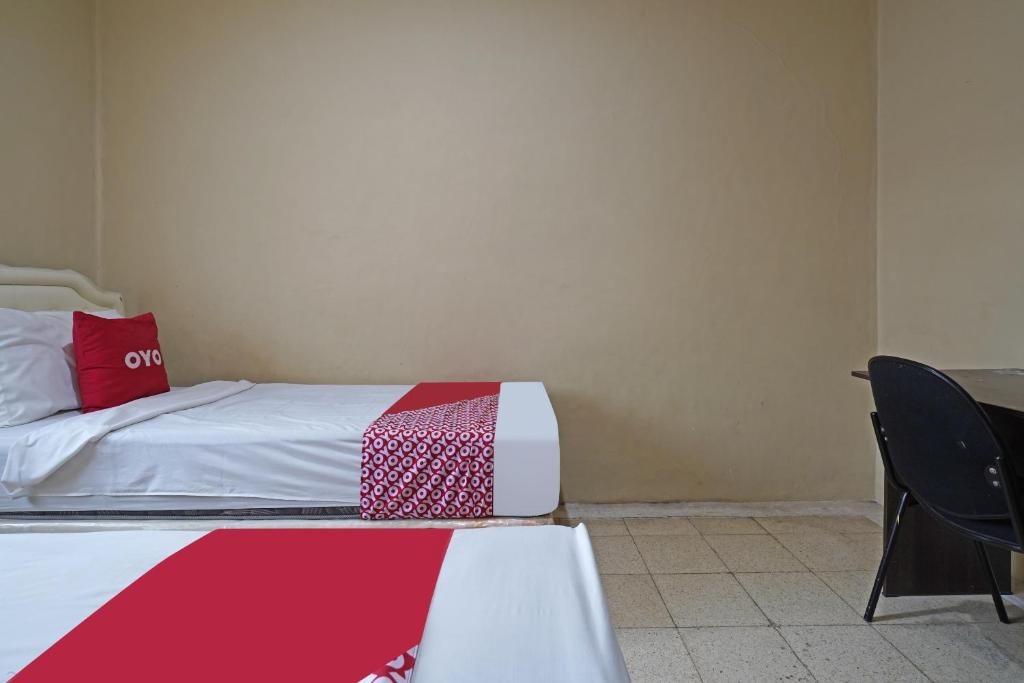 Postel nebo postele na pokoji v ubytování Super OYO 91350 Garden Hostel