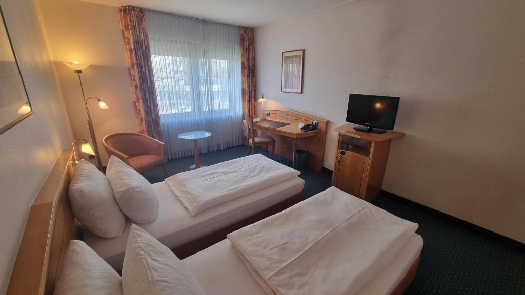 Postel nebo postele na pokoji v ubytování Hotel Panorama Hamburg-Billstedt