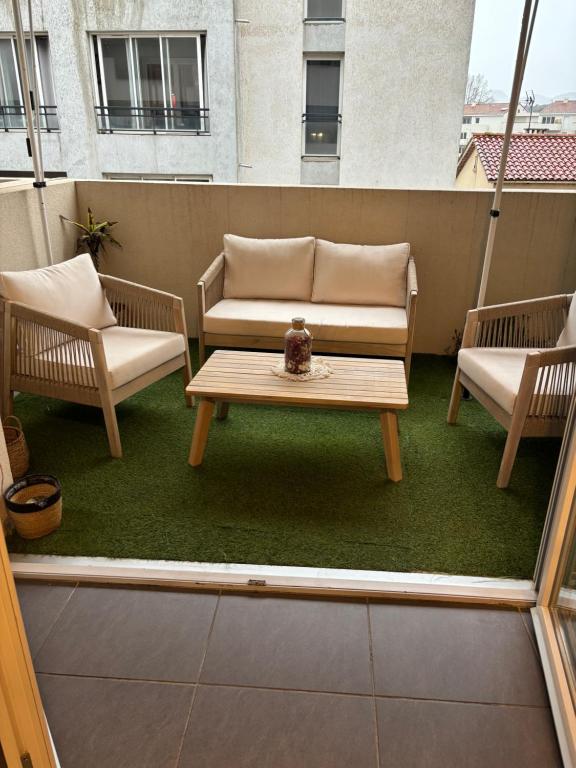 a patio with two chairs and a table and a couch at Appart cosy in La Seyne-sur-Mer