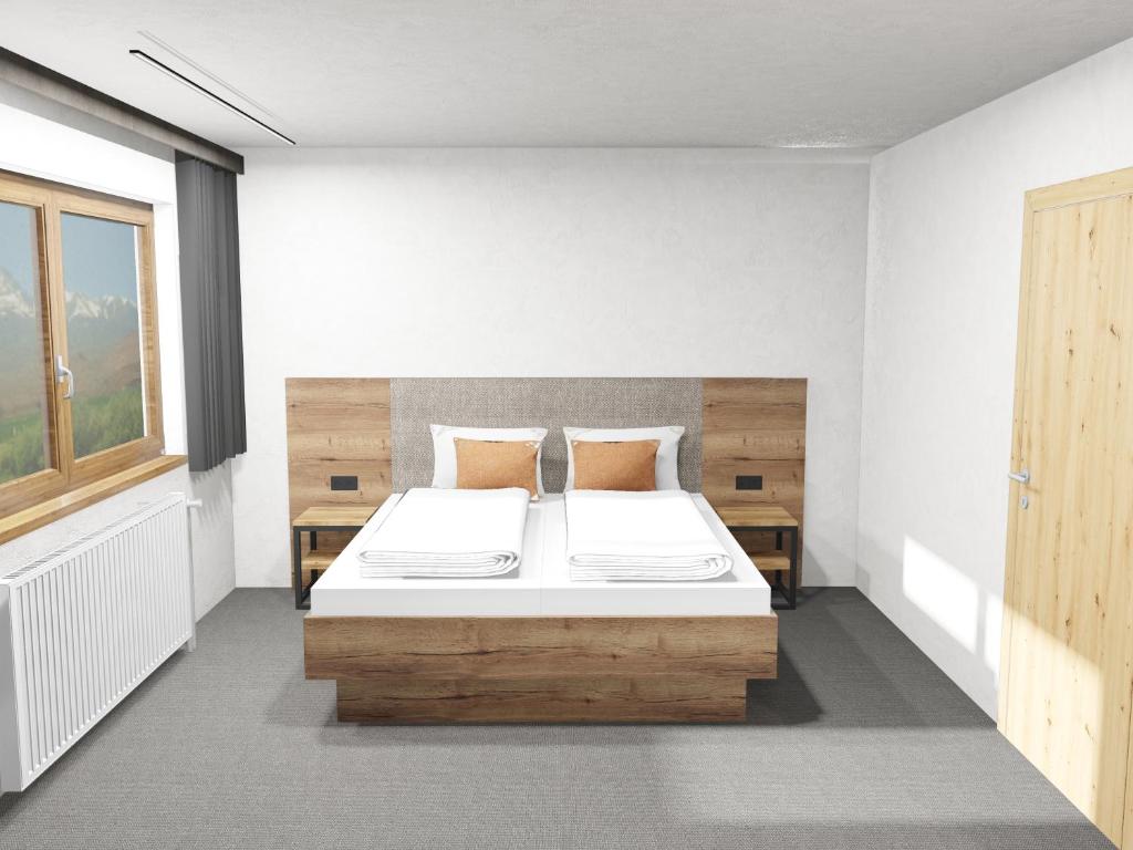A bed or beds in a room at Haus Enzian