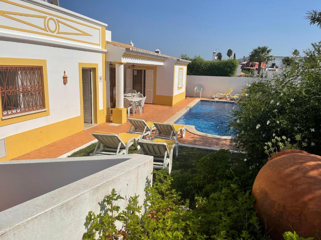 a villa with a swimming pool and a house at Villa Ana in Albufeira