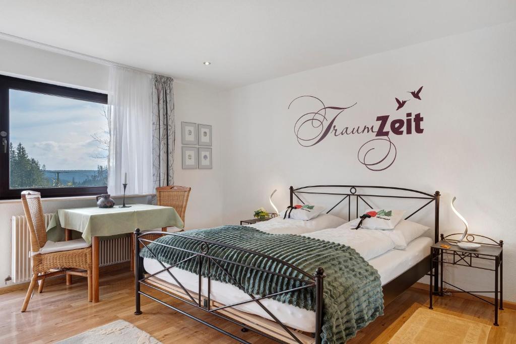 a bedroom with a bed and a sign on the wall at Haus Janßen-Wehrle in Titisee-Neustadt