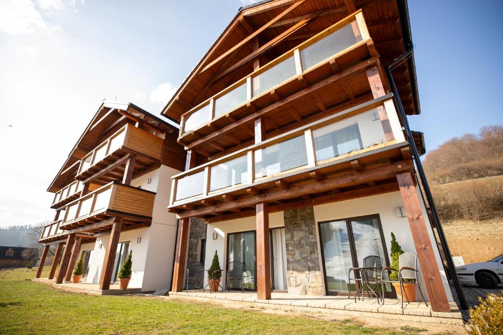 a house with large windows on the side of it at ZAPAČE Mýto apartmánový dom in Mýto pod Ďumbierom
