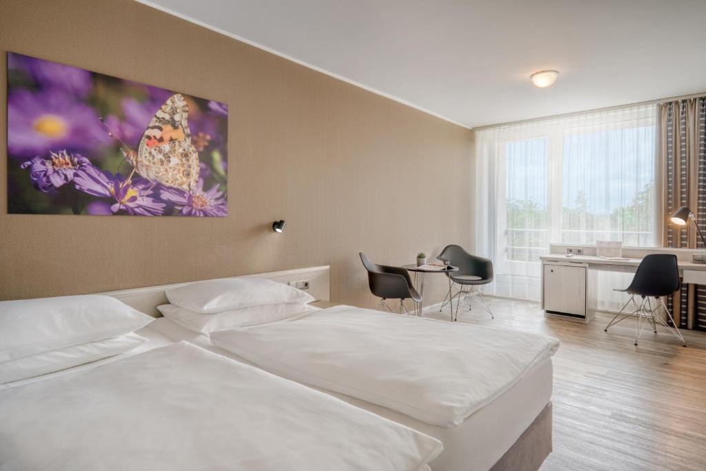 Postel nebo postele na pokoji v ubytování PARKHOTEL Hameln - ehemals Mercure Hotel Hameln