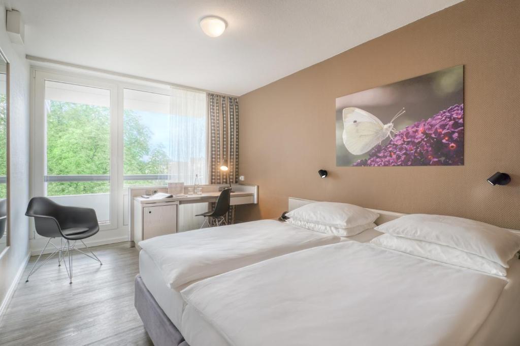 Postel nebo postele na pokoji v ubytování PARKHOTEL Hameln - ehemals Mercure Hotel Hameln