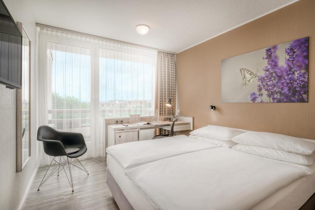 Postel nebo postele na pokoji v ubytování PARKHOTEL Hameln - ehemals Mercure Hotel Hameln
