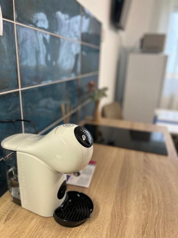 a hair dryer sitting on top of a table at SpaGo Apartment in Hajdúszoboszló