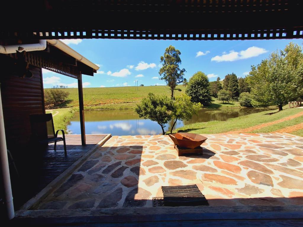 a swimming pool with a view of a lake at Strathavon Cottage in Machadodorp