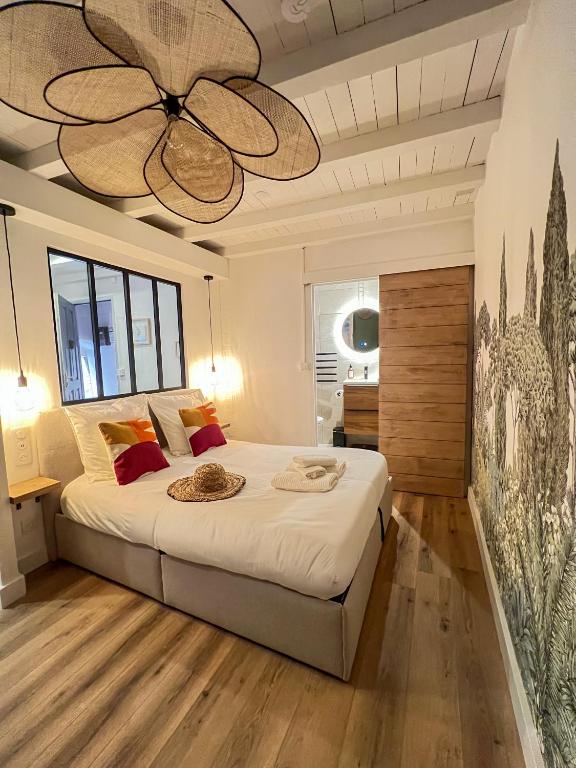 une chambre avec un grand lit avec un ventilateur de plafond dans l'établissement Appartement citadelle Bonifacio Appolonie, à Bonifacio