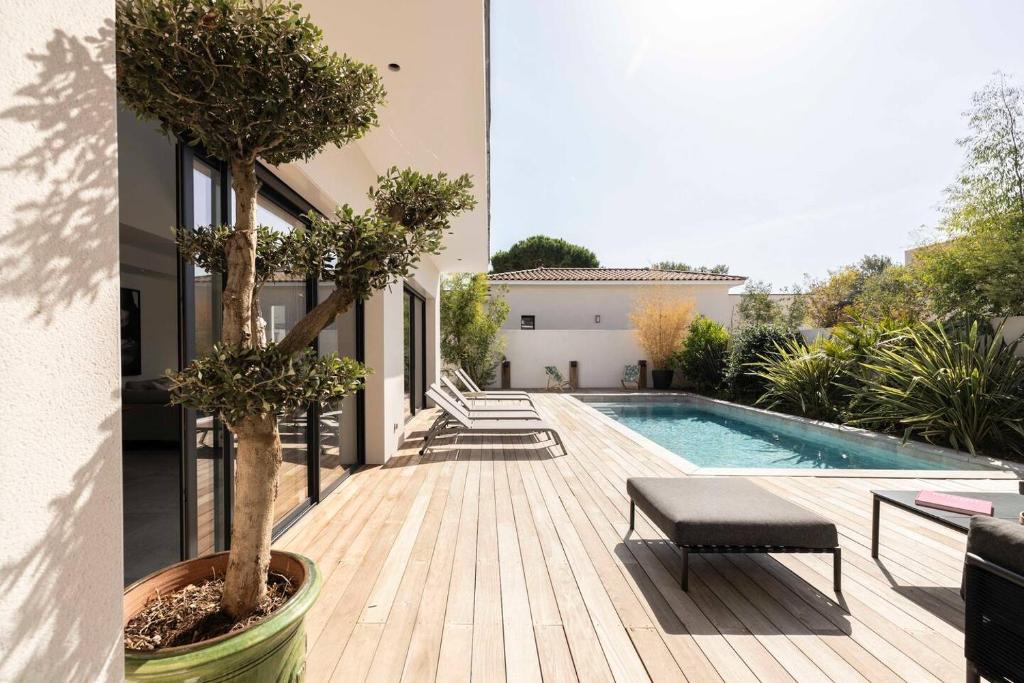 a villa with a swimming pool and a house at Villa Yuna Heated Swimming Pool Beach in Cap d'Agde