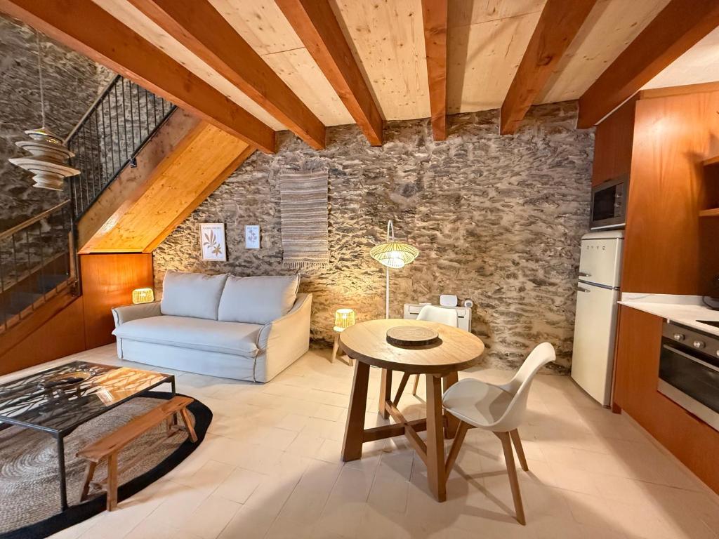 a kitchen and living room with a table and a couch at Agi Porthos Apartments in Roses